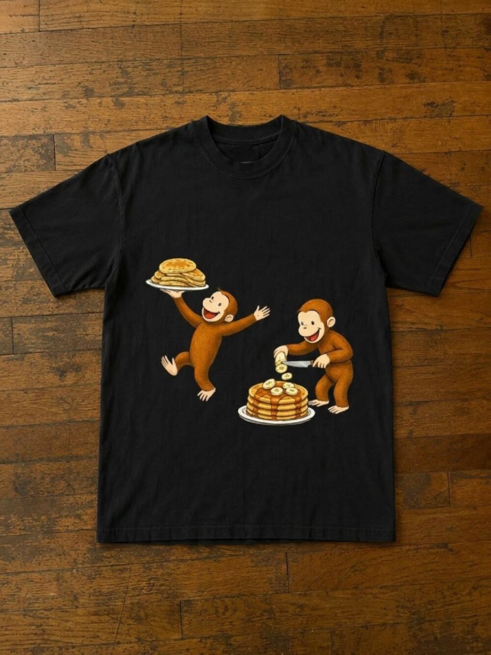 Curious George Peeling a Banana Modern Cartoon with Logo Unisex Tshirt